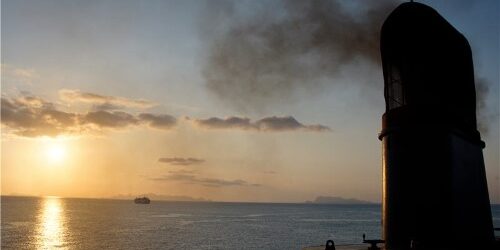 shutterstock_1320674390_tae_py15mu_a-ship-funnel-is-exhausting-black-polluted-smoke-with-deep-blue-sea-in-twilight-time-photo